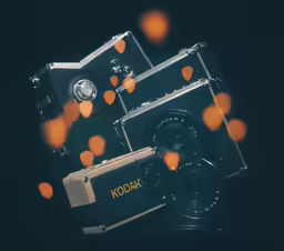 an old kodak camera with some orange lights