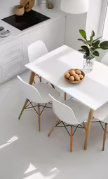 the table and chairs are all white with no people around it