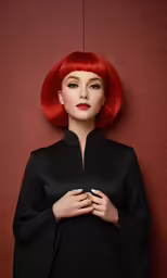 a woman with red hair standing next to a wall