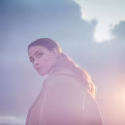 a woman stands with her head close to the ground