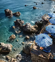an image of beach with blue and white umbrellas