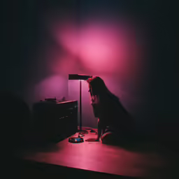 a woman with long hair is sitting in front of a radio