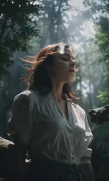 a girl that is standing in the grass with her hair in the wind