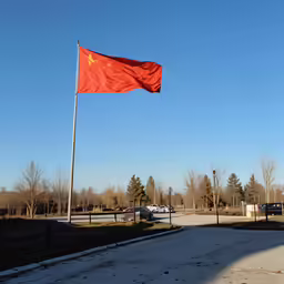 a large chinese flag flying on a flagpole