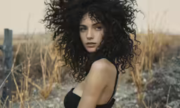 a portrait of a girl in the background with curly hair