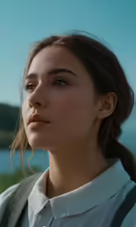 a woman with long hair and a tie looking at something