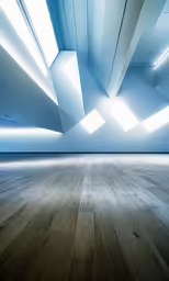 a large wooden floor is shown with white walls