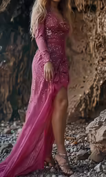 a woman standing on rocks near a cliff
