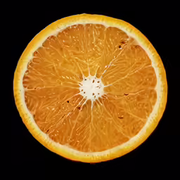 an orange cut in half sitting on a table