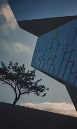 a large building sitting next to a tree