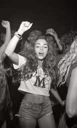 young lady dancing at club with crowd around her