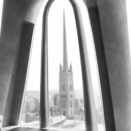 a view of some tall buildings from an arch