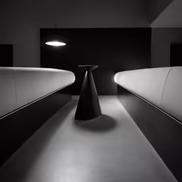 black and white photo of a dimly lit room with curved white benches