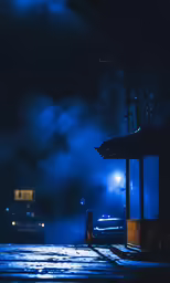 a man standing in the rain near an umbrella