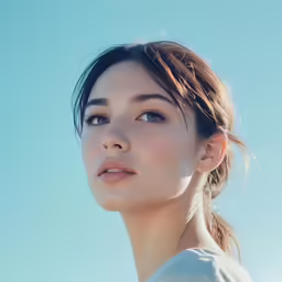 an asian woman wearing white poses for a portrait