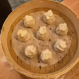 this is a brown bowl with food in it