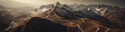 an aerial view of a mountains and road