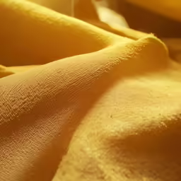 a banana sitting on a table cloth covered in cloth