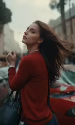a woman standing next to a parked car