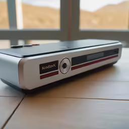 the electronic device is sitting on a wooden table