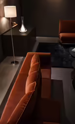 a corner sofa and table in the dark room