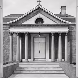 an old church with large columns and an entry