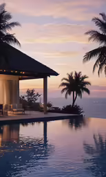 a gazebo and lounge chairs on the beach at sunset