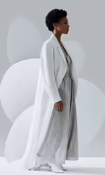 the woman in white coat and gray pants