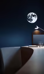 a table with a laptop, glassware and the moon hanging over it