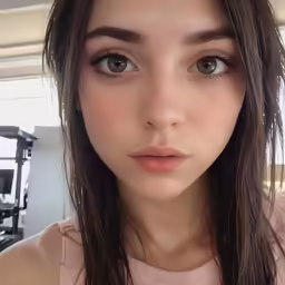 a woman with brown eyes standing in a gym