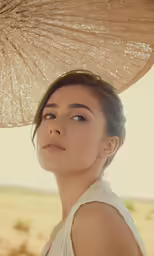 woman wearing an umbrella hat and white dress outdoors