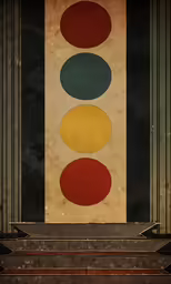 some red, yellow and green colors are next to a black wall