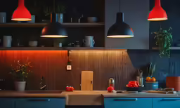 lights hang above the sink in a kitchen