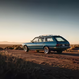 an old blue car in a desert plain