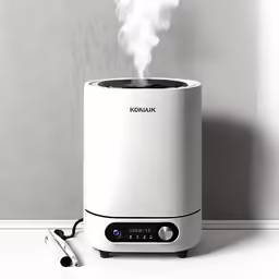 a white machine is on the ground as smoke goes from it