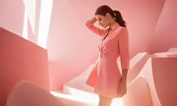 the woman is walking down the stairs in a pink outfit