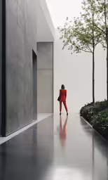 a man in red and orange suit walking down the road