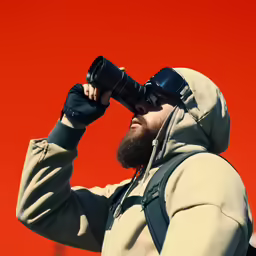 a person standing in front of a red background