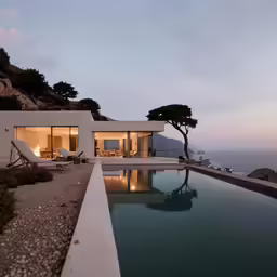 a house with an empty pool near the ocean