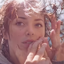 a woman has freckled hair and nails on her face