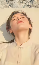woman laying down on the beach with her eyes closed