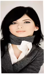 a woman with dark hair and a scarf in grey, wearing black and white