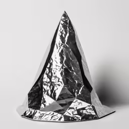 a metallic cone sitting on top of a white floor