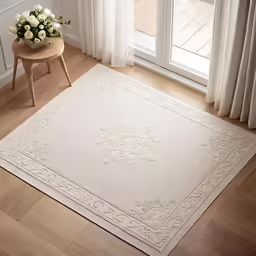 a room with large windows and white decor