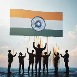 several people stand in front of a large indian flag
