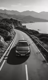 a car driving down the road to the shore