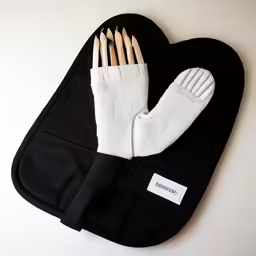 four wooden nails are inserted into the arm of a black pouch