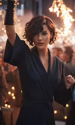woman in a robe waving her arms with firework behind her