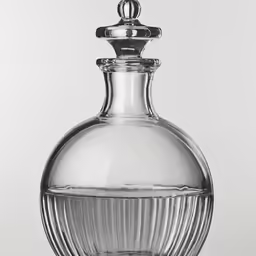 a clear glass perfume bottle with an oval shaped top