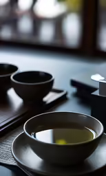 a soup bowl on a table with an appliance beside it